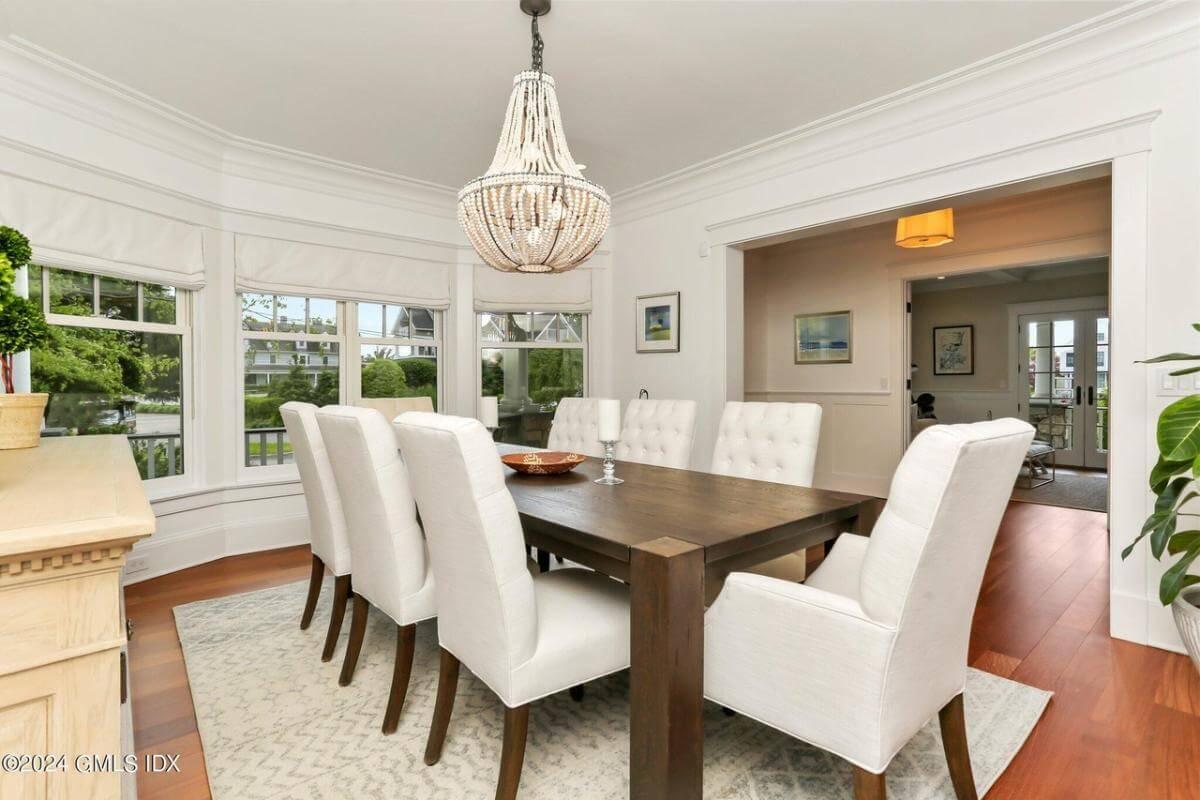 Bright Dining Room with Tufted Chairs and a Statement Chandelier
