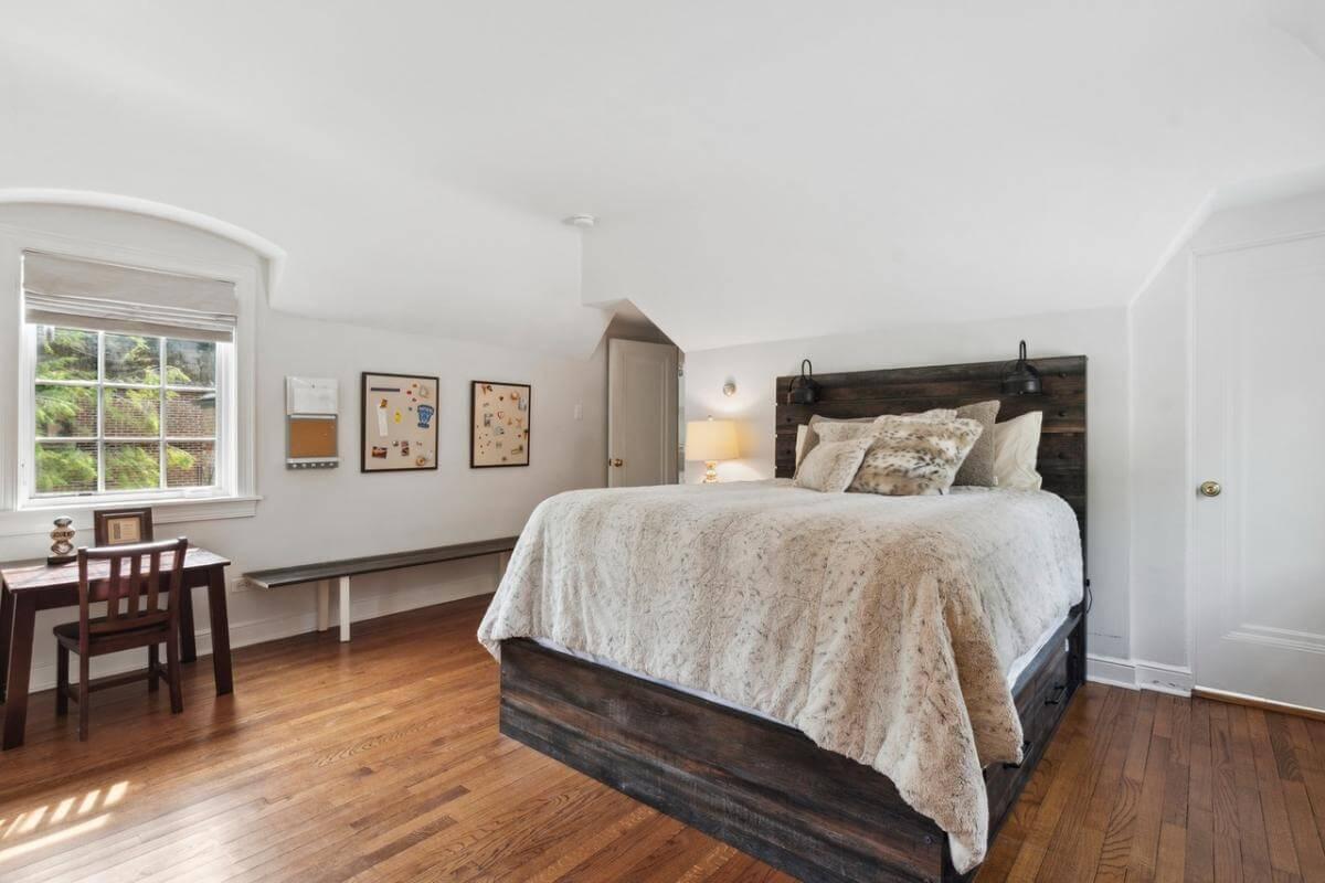 Bedroom Retreat with a Rustic Wood Bed and Cozy Nook