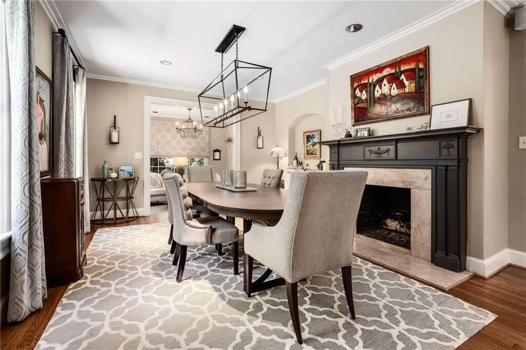 Explore This Elegant Dining Room Anchored by a Black Mantel Fireplace