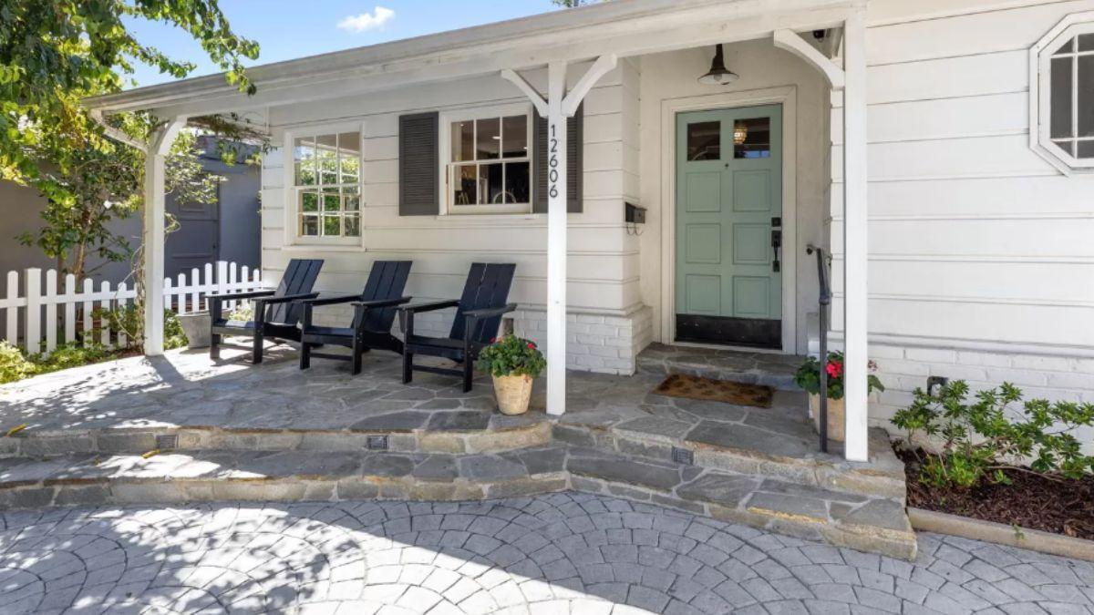 Welcoming Front Porch with Adirondack Chairs and Mint Door