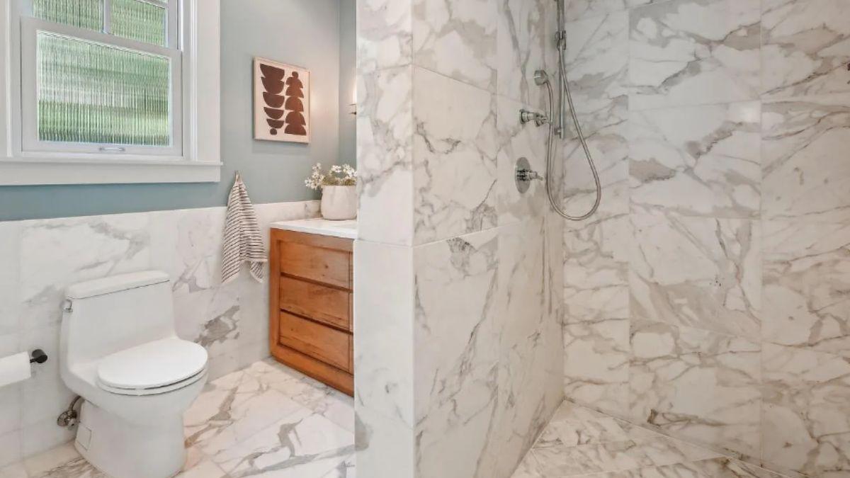 Explore This Bathroom with Luxe Marble and a Warm Wood Vanity