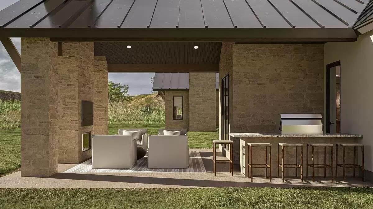 Outdoor Retreat with a Stone Fireplace and Bar Seating