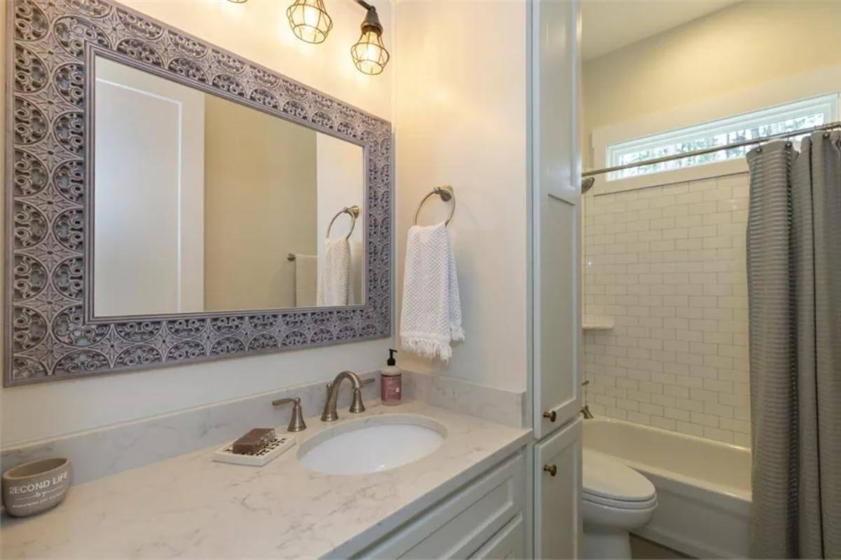 Spot the Ornate Mirror Frame Enhancing This Craftsman Bathroom