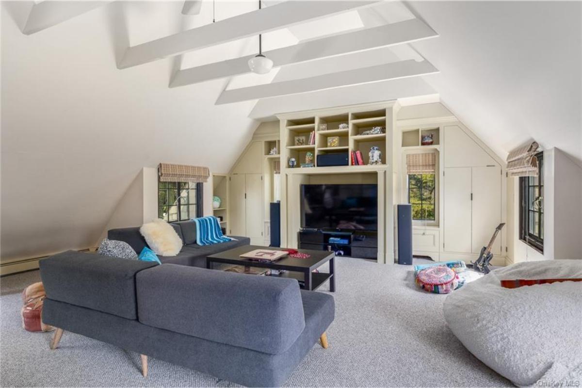 Spacious Attic Retreat with Cozy Seating Area and Built-Ins