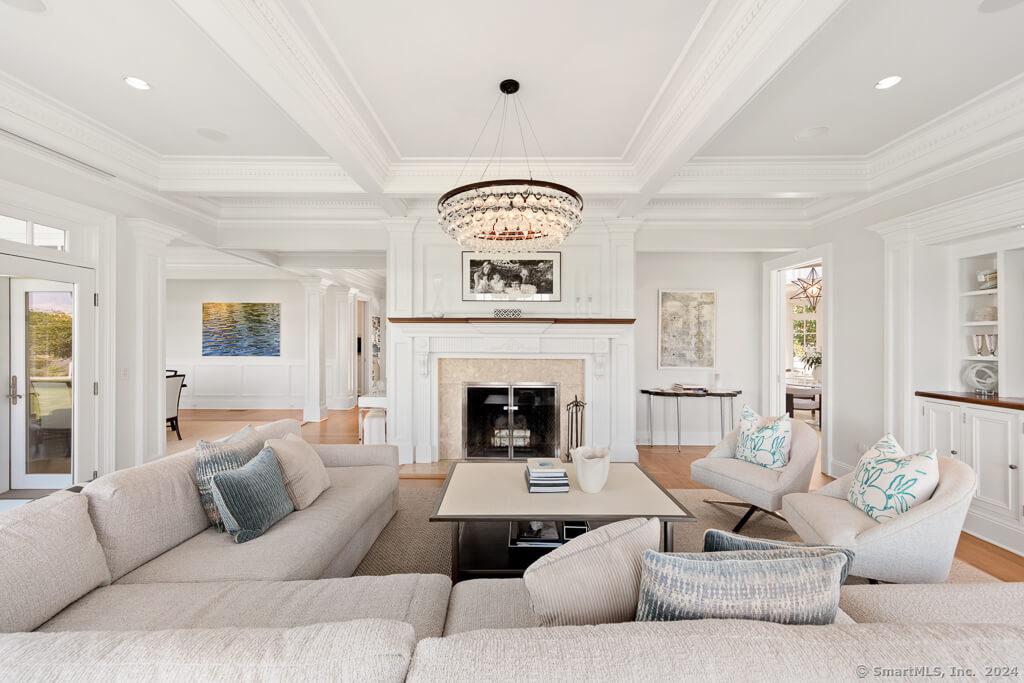 Elegant Living Room with a Striking Chandelier and Cozy Fireplace