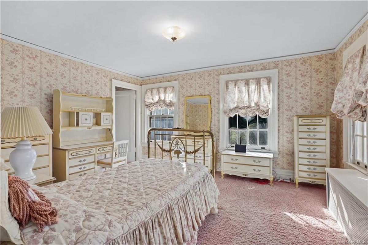 Vintage Bedroom with Delicate Floral Accents and Brass Bed Frame