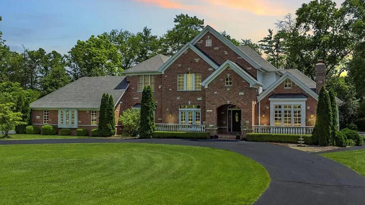 A Grand Entrance with Classic Brickwork and Timeless Landscaping