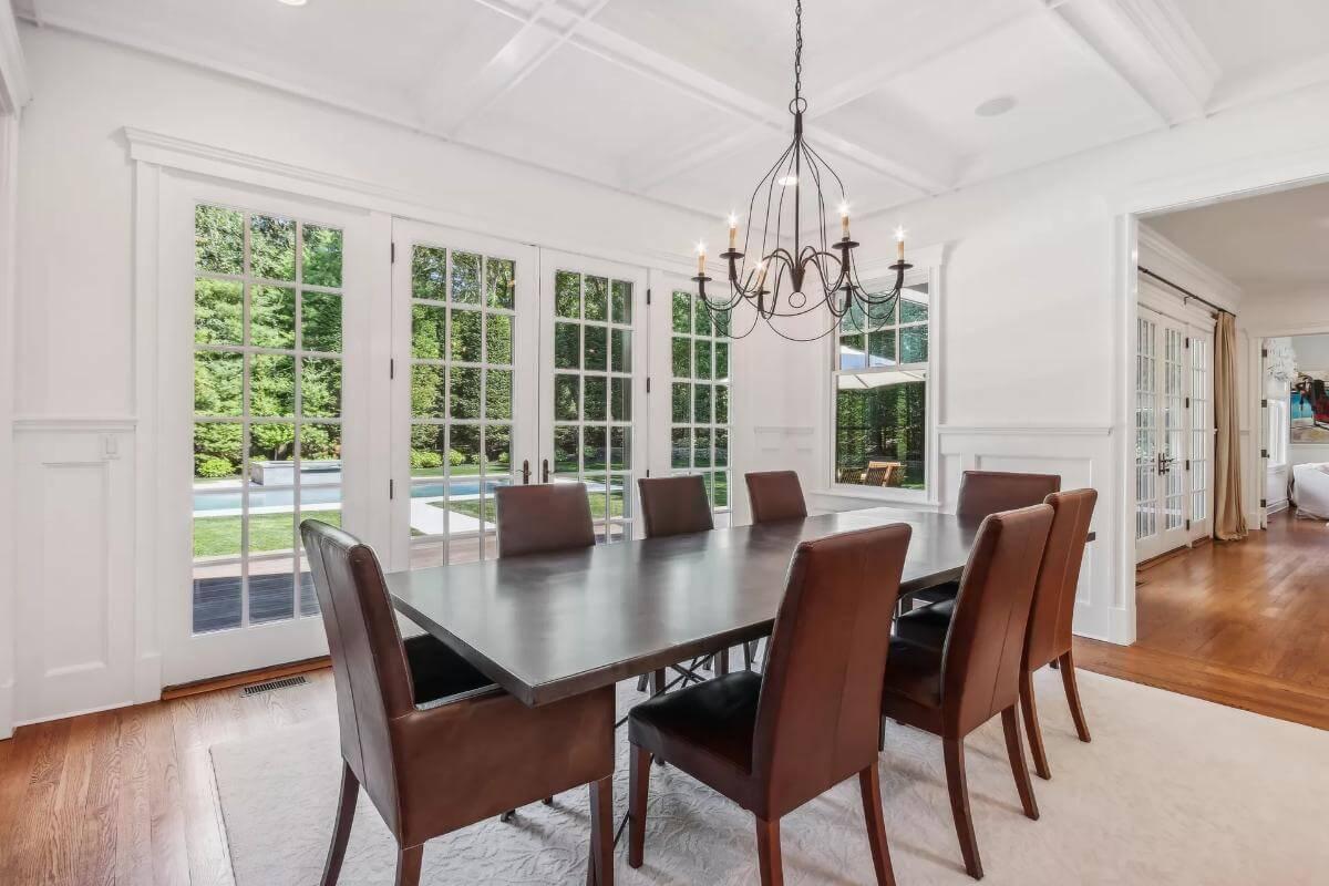 Expansive Dining Room with French Doors Opening to Poolside Views