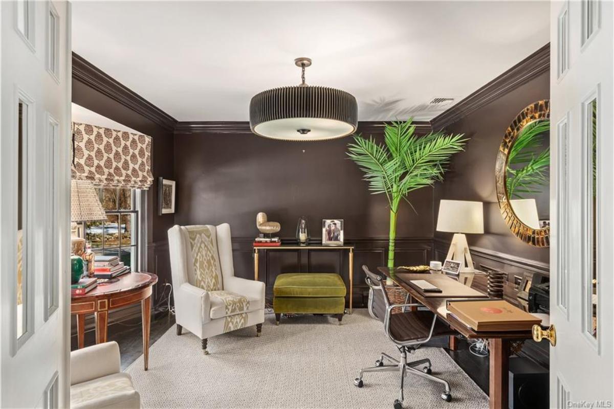 Discover This Inviting Home Office with Bold Dark Walls and a Unique Circular Mirror