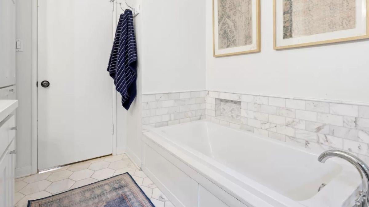 Elegant Bathroom with a Marble-Tiled Soaking Tub