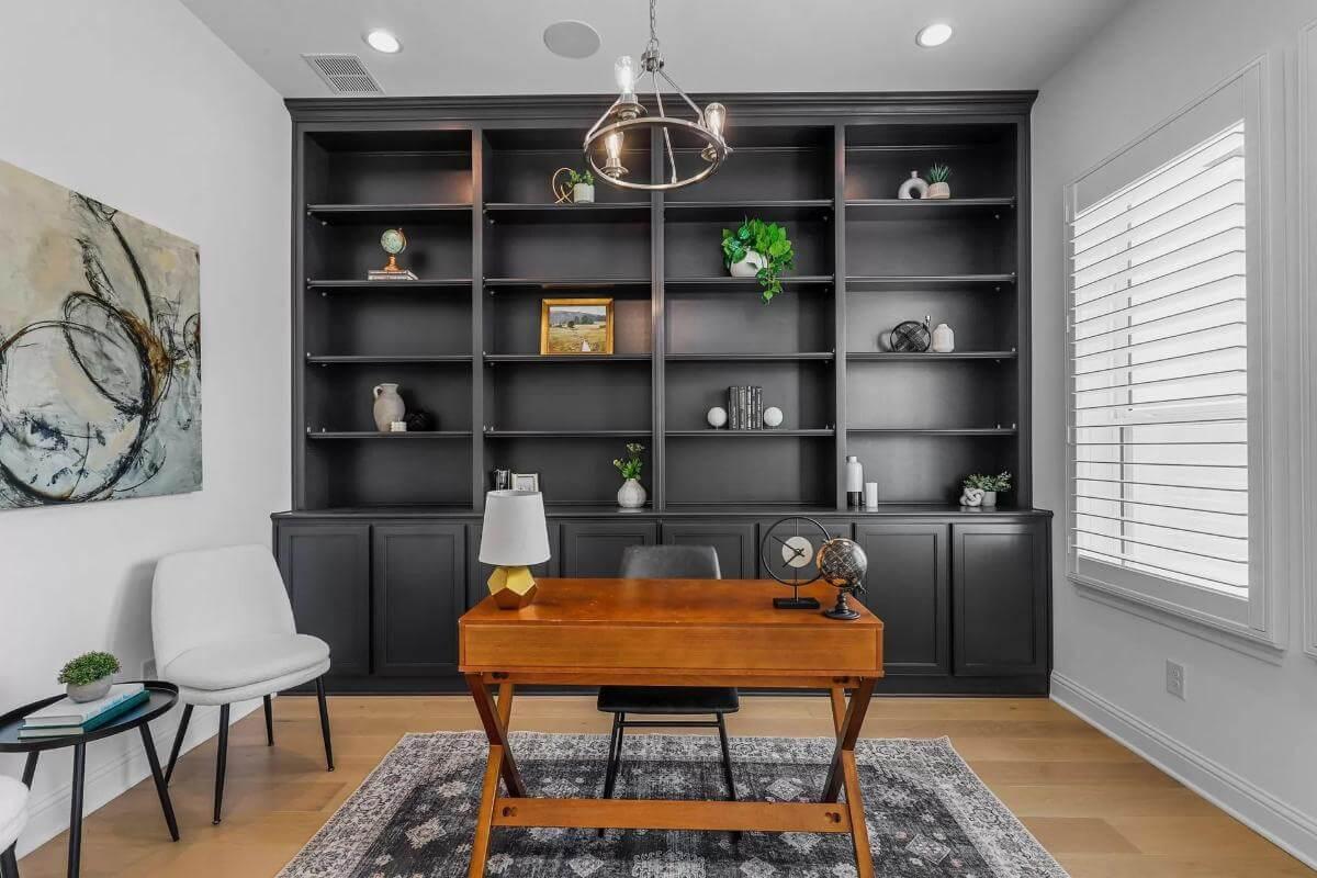 Look at This Home Office With a Statement Wall of Black Shelves