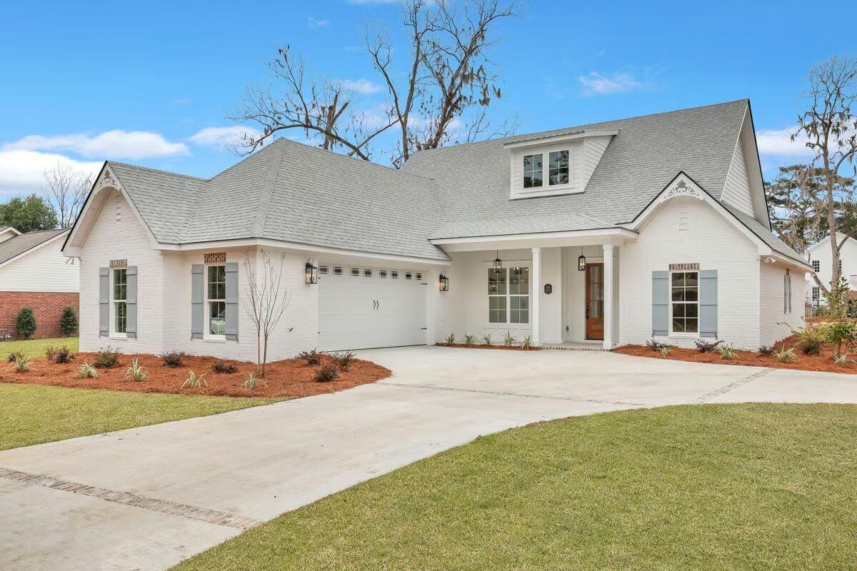 Charming White Brick Exterior with Classic Dormer Windows
