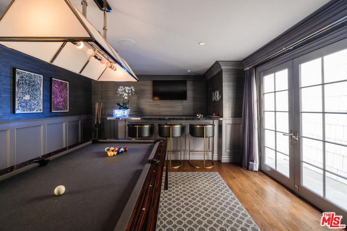Chic Game Room Featuring a Sleek Bar and Pool Table