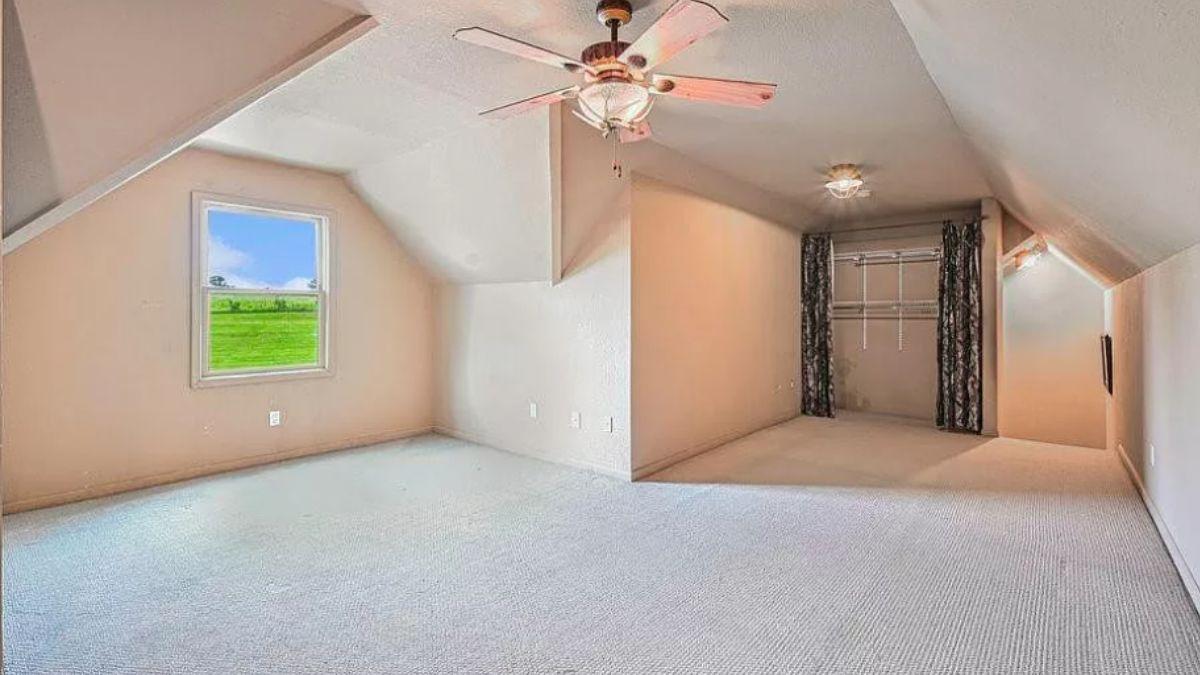 Versatile Attic Space with Natural Light and a Breezy Ceiling Fan