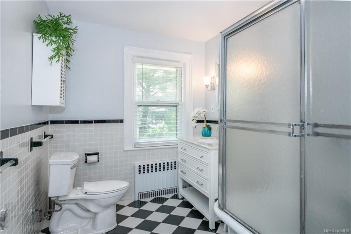 Notice the Checkered Tile Flooring in This Classic Bathroom