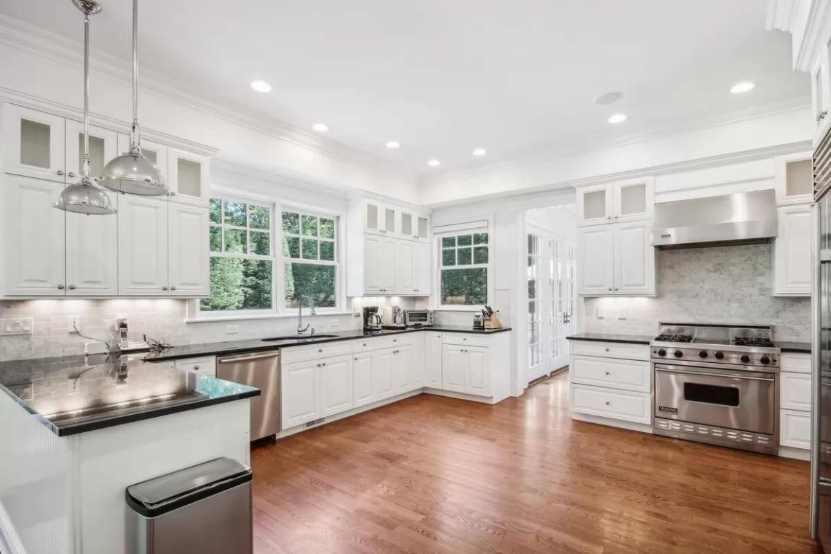 Elegant Craftsman Kitchen Featuring Black Countertops and Ample Cabinetry
