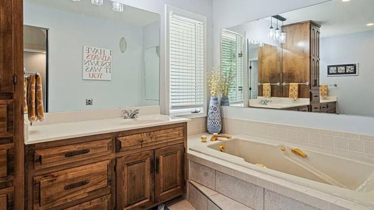 Notice the Rustic Cabinetry in This Relaxing Bathroom Suite