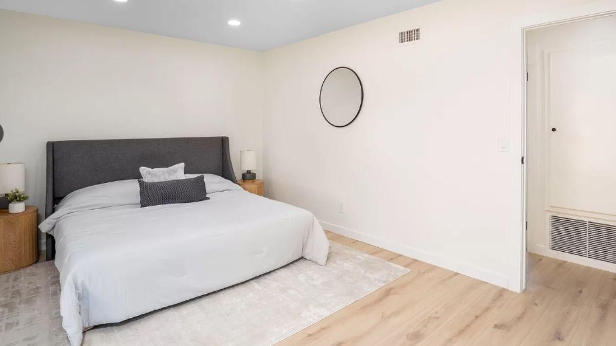 Simple Bedroom Design with a Stylish Round Mirror