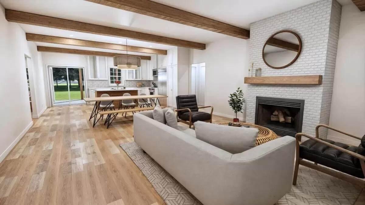 Open-Concept Living with Exposed Wooden Beams and a Brick Fireplace