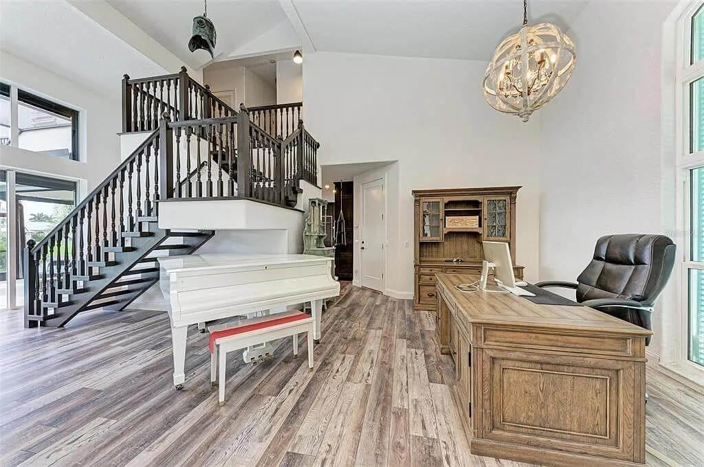 Welcoming Home Office with a Statement Staircase and White Piano