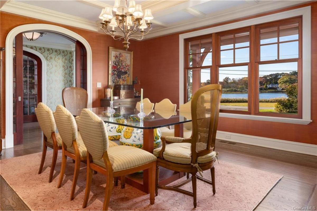 Elegant Dining Room with a Glass Table and Lake Views
