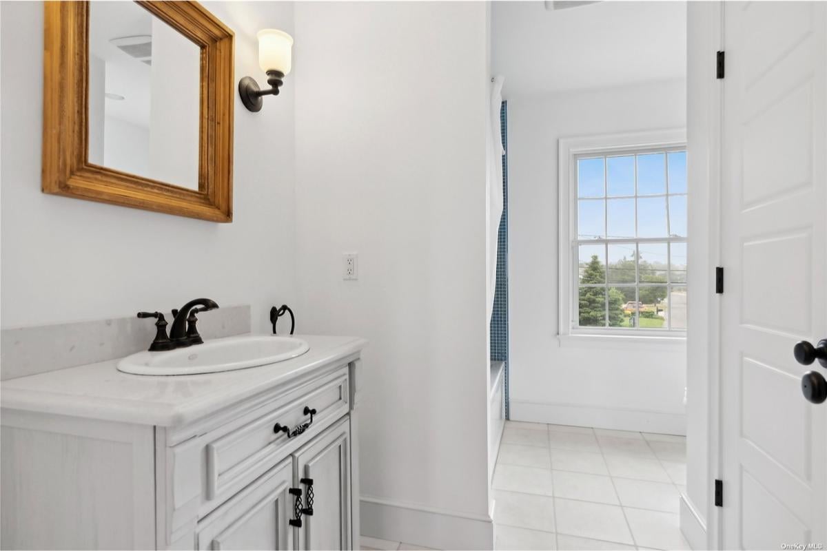 Bright Bathroom with Rustic Vanity and Scenic Window