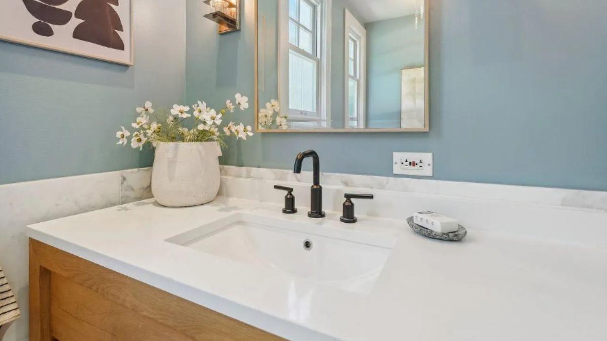 Check Out This Bathroom Highlighting a Marble Counter and Matte Black Fixtures