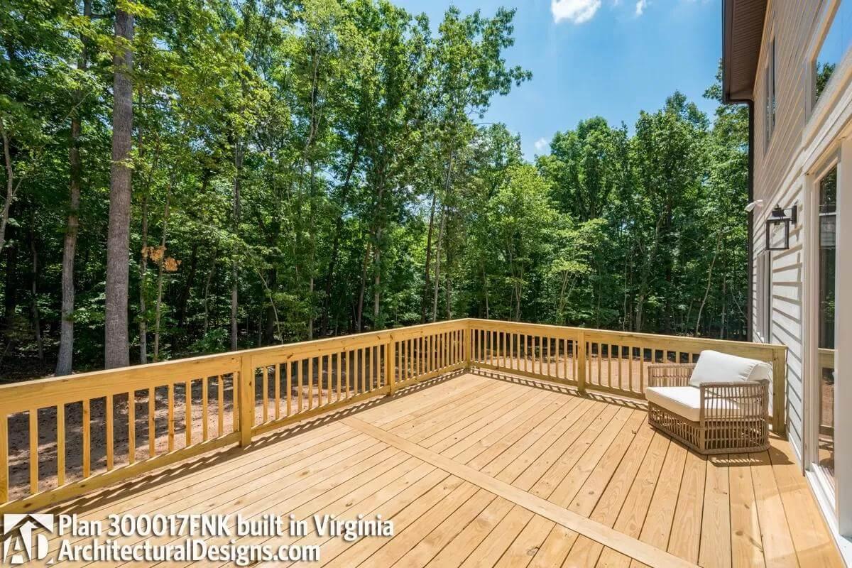 Step Out onto This Expansive Deck Surrounded by Lush Greenery