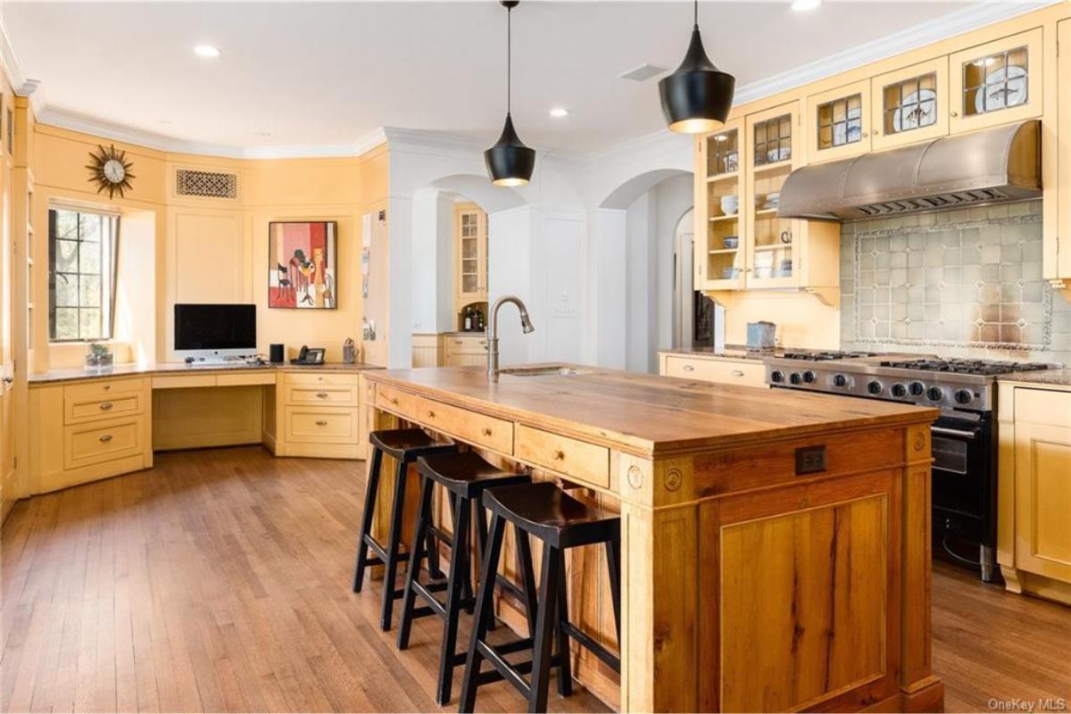 Check Out This Kitchen with a Sunburst Clock and Built-In Desk Nook