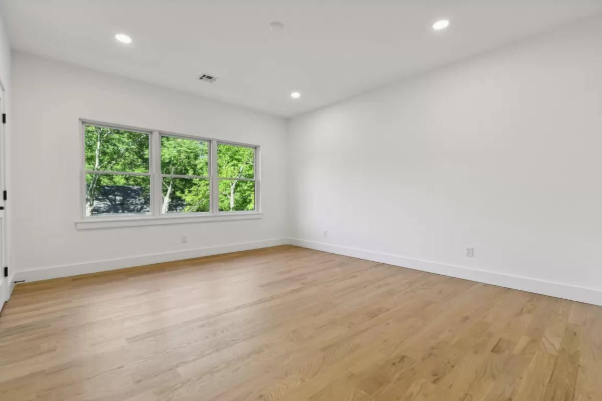 Expansive Room with Stunning Hardwood Floors and Natural Light
