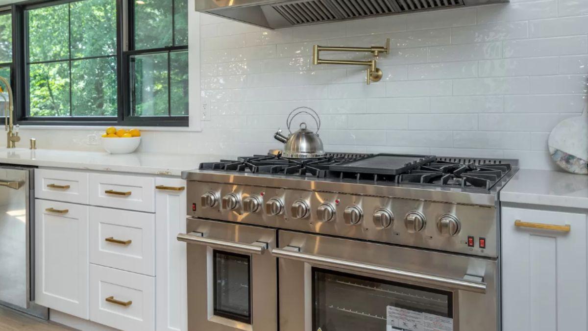 Notice the Bold Brass Accents and Professional Range in This Stylish Kitchen