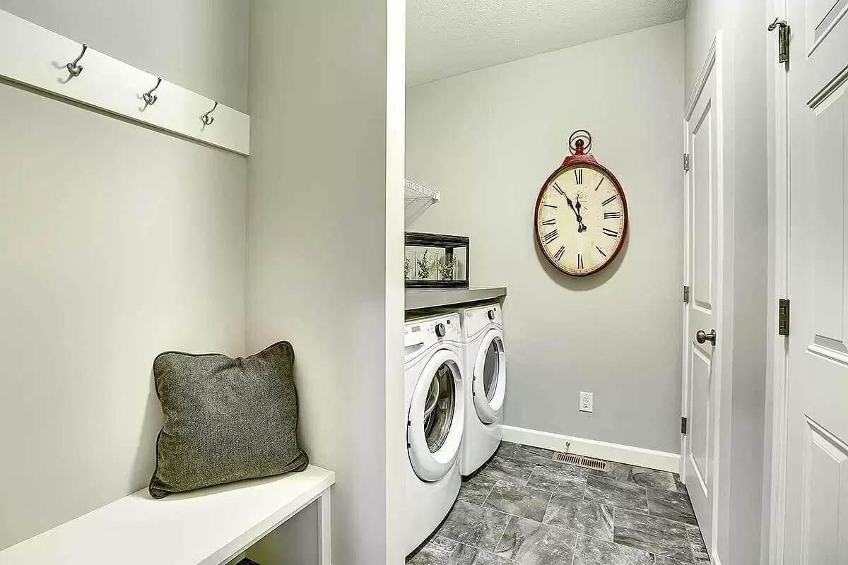 Efficient Laundry Room with a Giant Wall Clock for Style