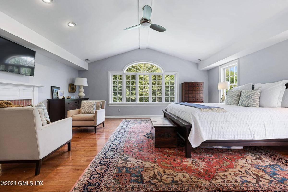 Spacious Master Bedroom with a Striking Arched Window