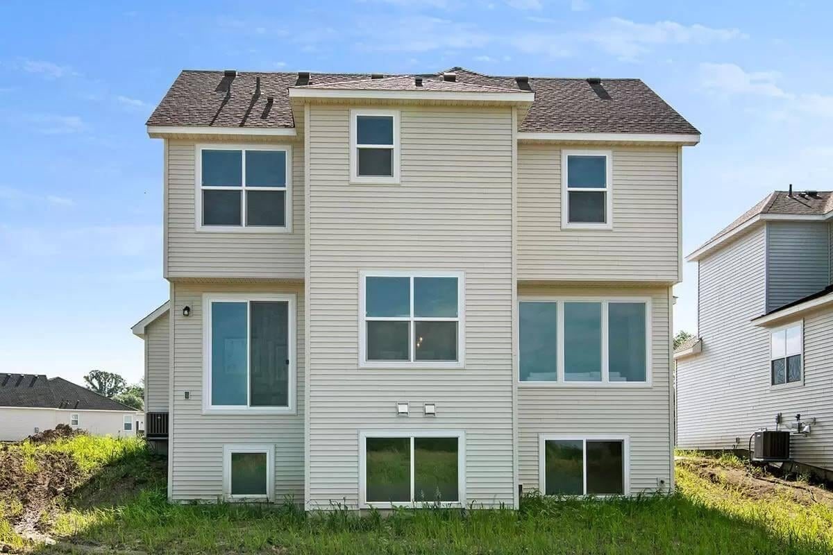 Rear View Highlighting Ample Windows and Vinyl Siding