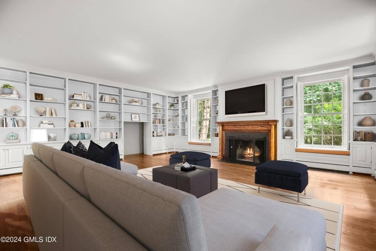 Spacious Living Room Highlighting Built-In Shelving and a Cozy Fireplace