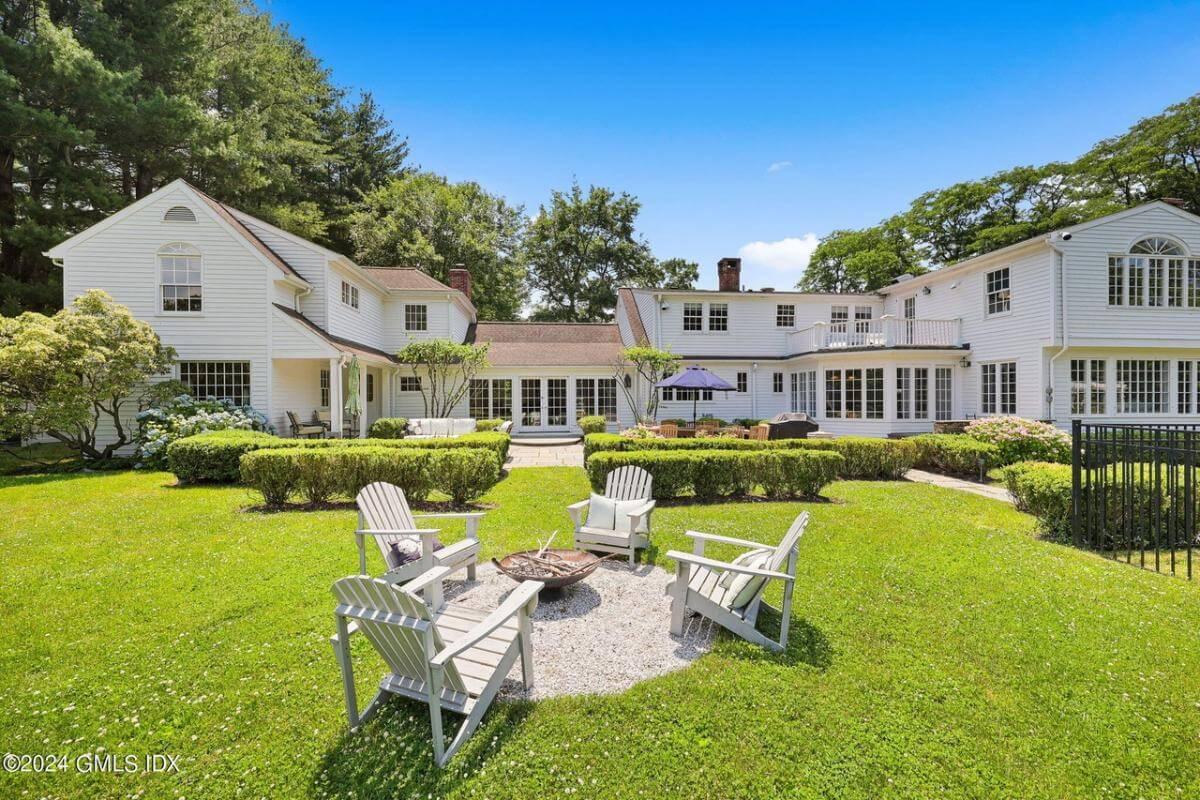Classic Colonial Backyard with Adirondack Seating Around a Fire Pit