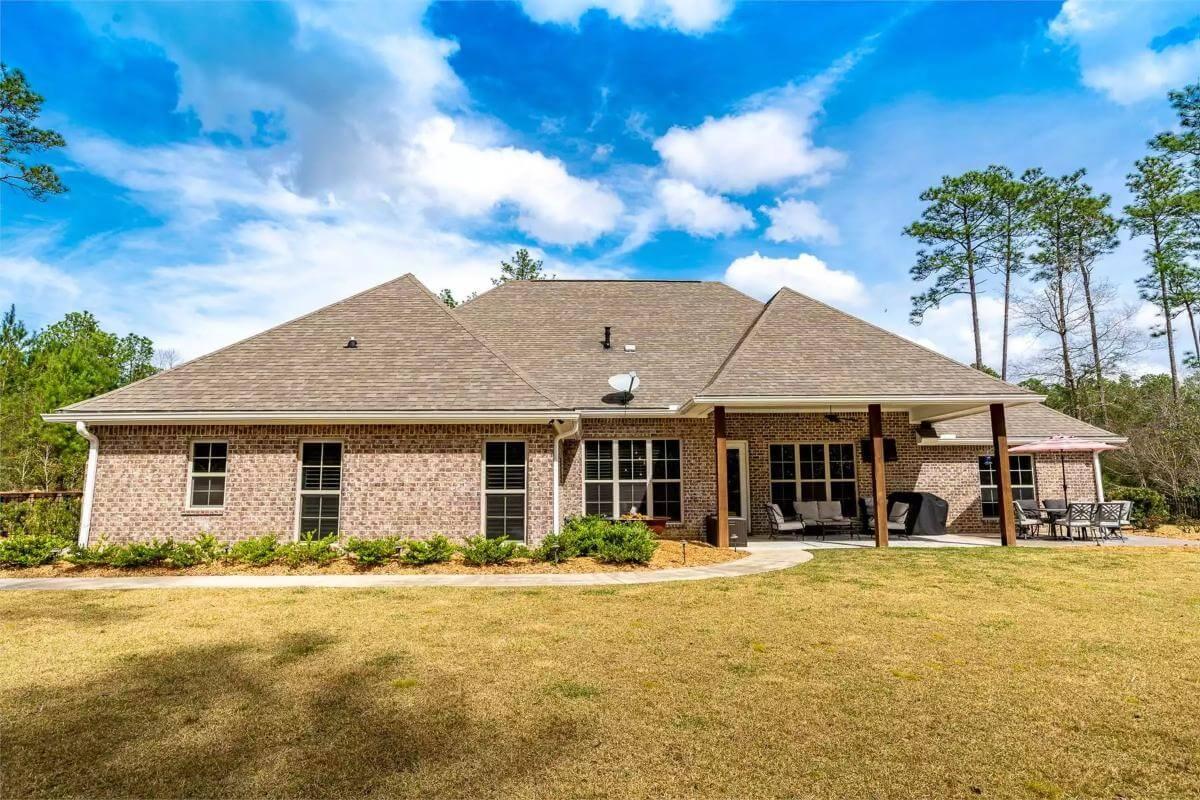 Spacious Backyard Patio with Brick Detailing and Ample Seating