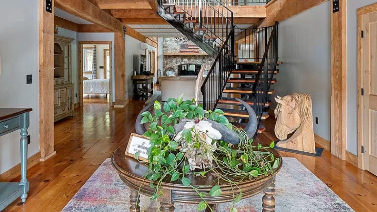 Wow, Look at the Industrial Spiral Staircase in This Inviting Foyer