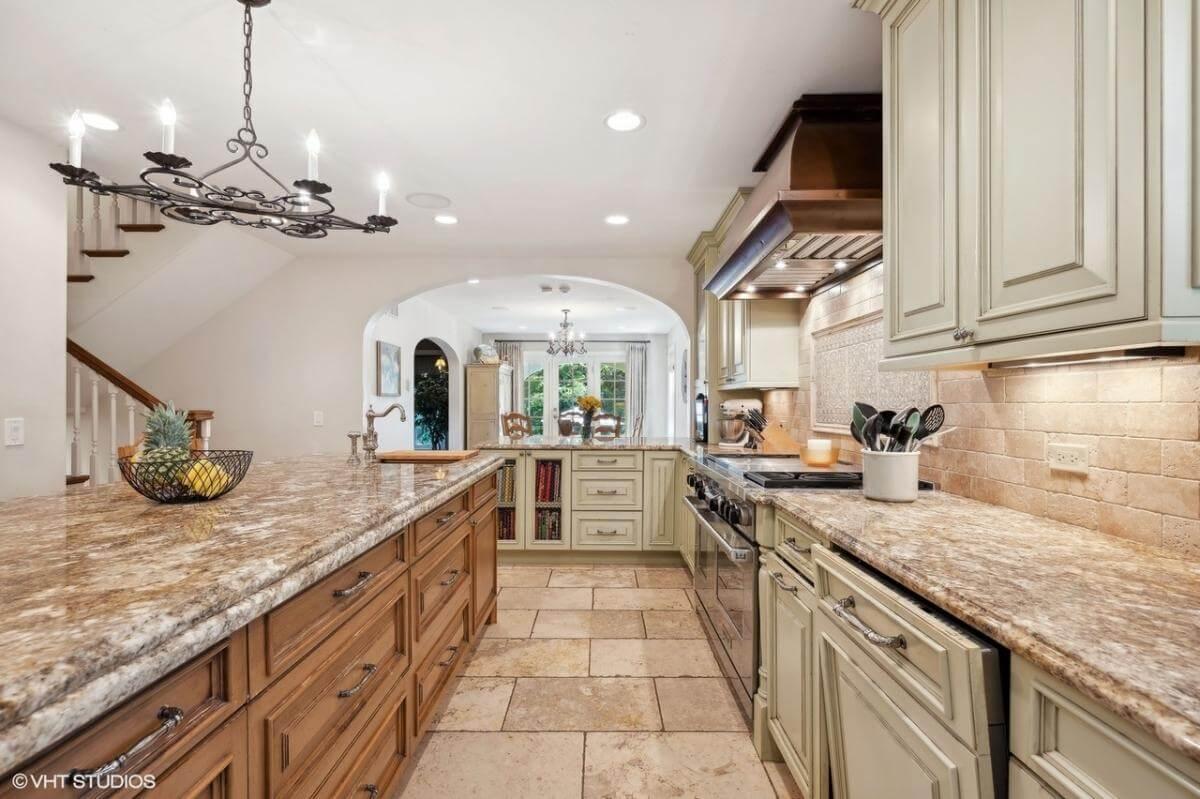 Traditional Kitchen with Textured Granite and Intricate Ironwork Chandelier