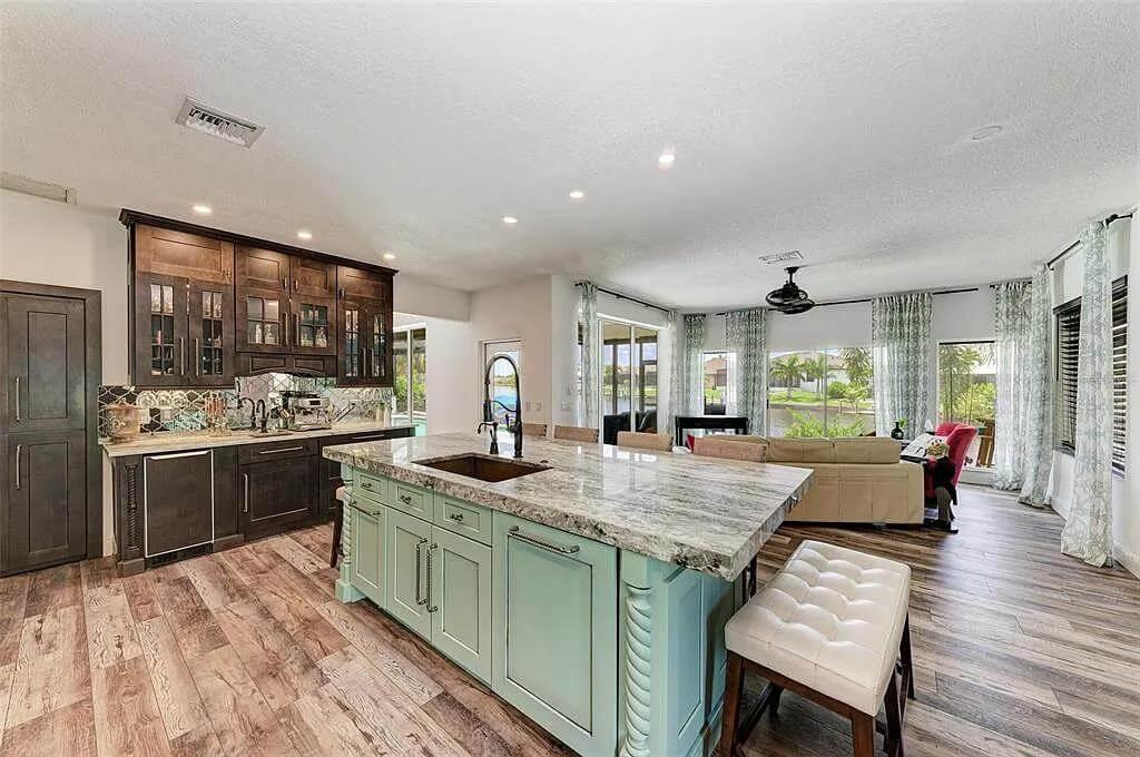 Notice the Artistic Backsplash Enhancing the Dark Wood Cabinets