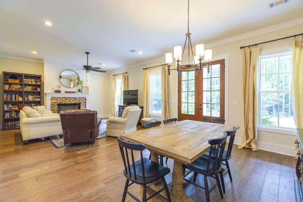 Experience the Blend: Cozy Craftsman Dining and Living Area with Classic Fireplace