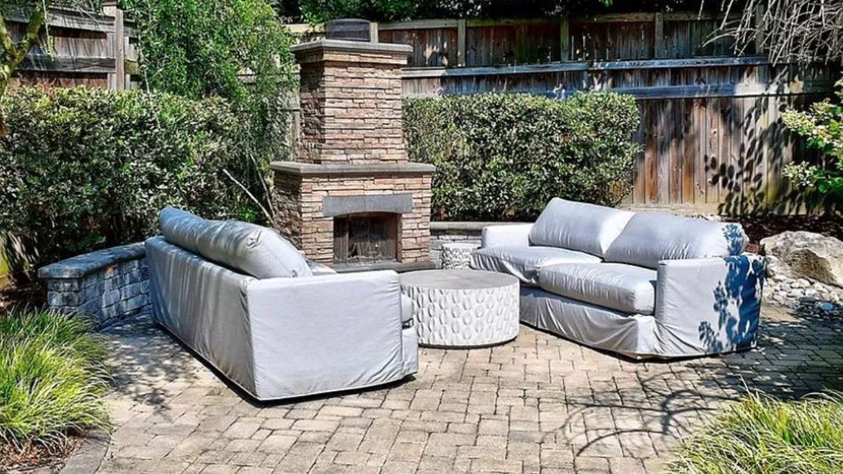 Outdoor Gathering Spot with Brick Fireplace and Comfortable Seating