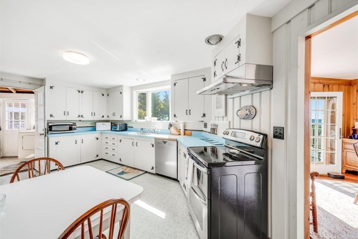 Notice the Retro Charm with Sky Blue Countertops in This Kitchen