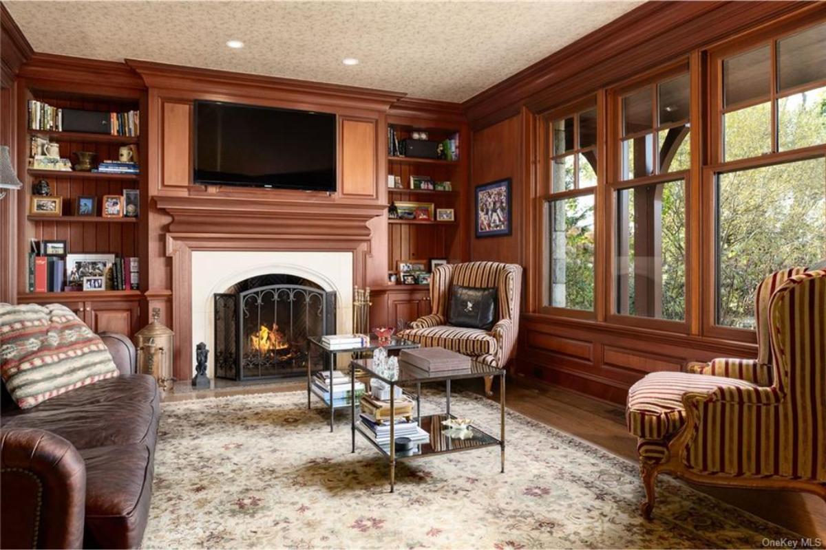 Classic Library Feel with a Grand Fireplace and Built-In Shelving