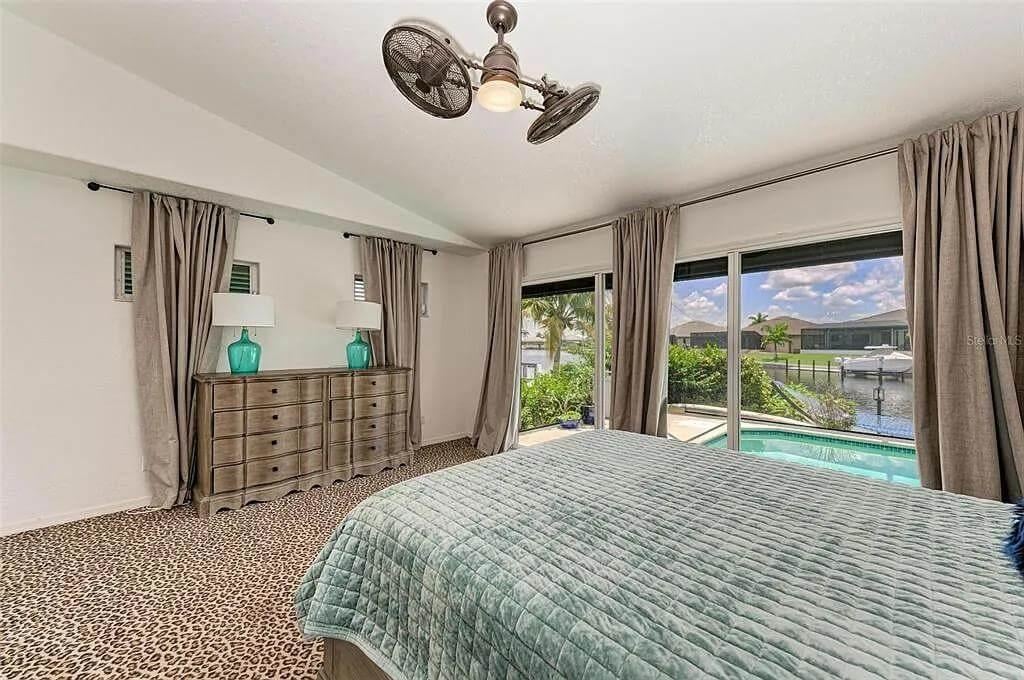 Bedroom with Leopard Print Carpet and Waterfront Views That Capture Attention