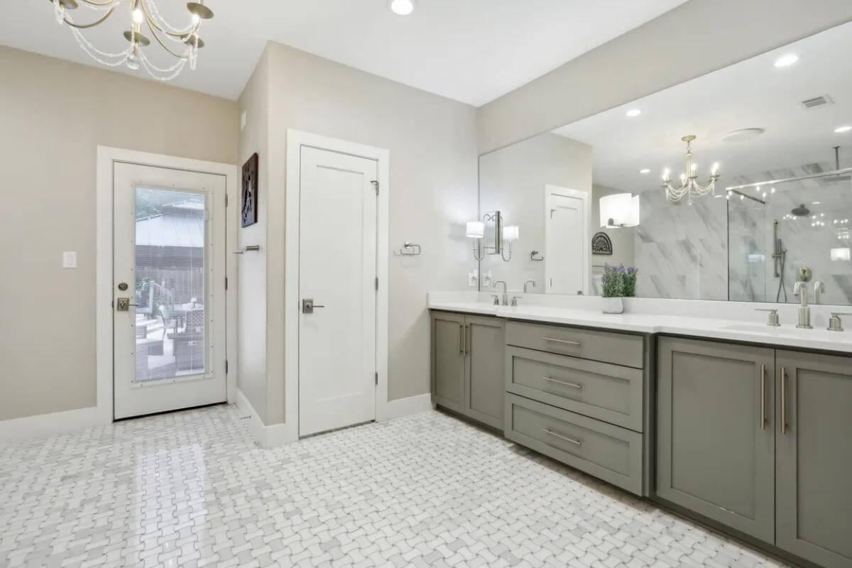 Spacious Bathroom with a Chic Double Vanity and Elegant Chandelier