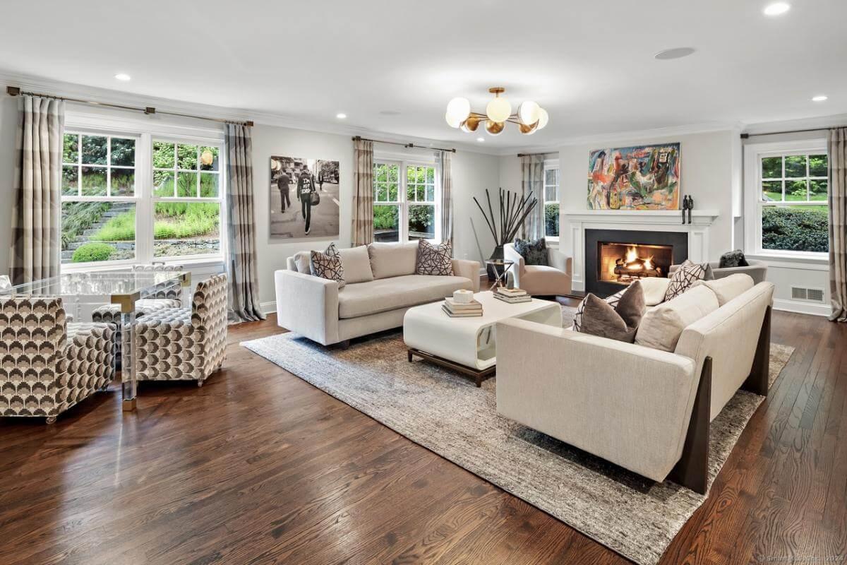 Relax in This Elegant Living Room With a Captivating Art Piece Above the Fireplace