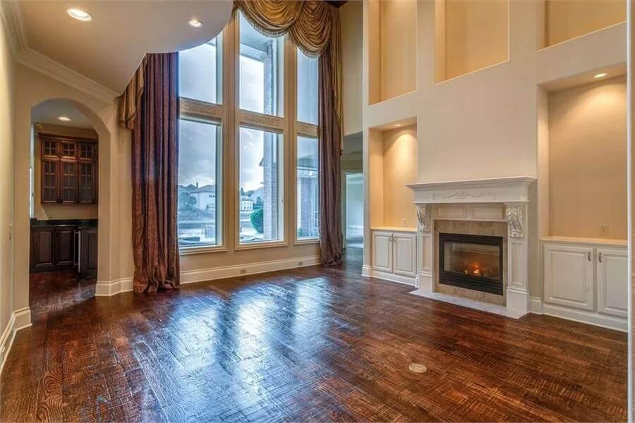 Spacious Living Room with Dramatic Windows and Classic Fireplace