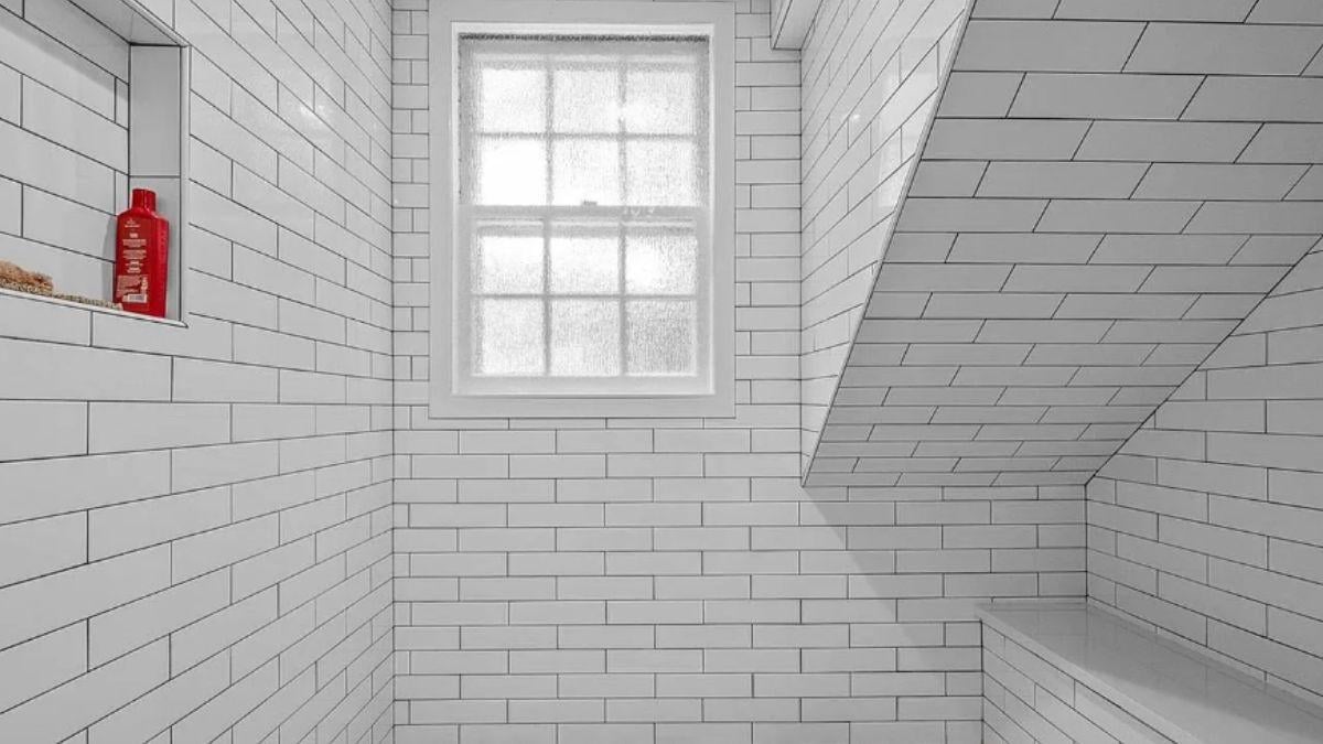 Look at the Subtle Beauty of the Subway Tiles and Sloped Ceiling in This Shower