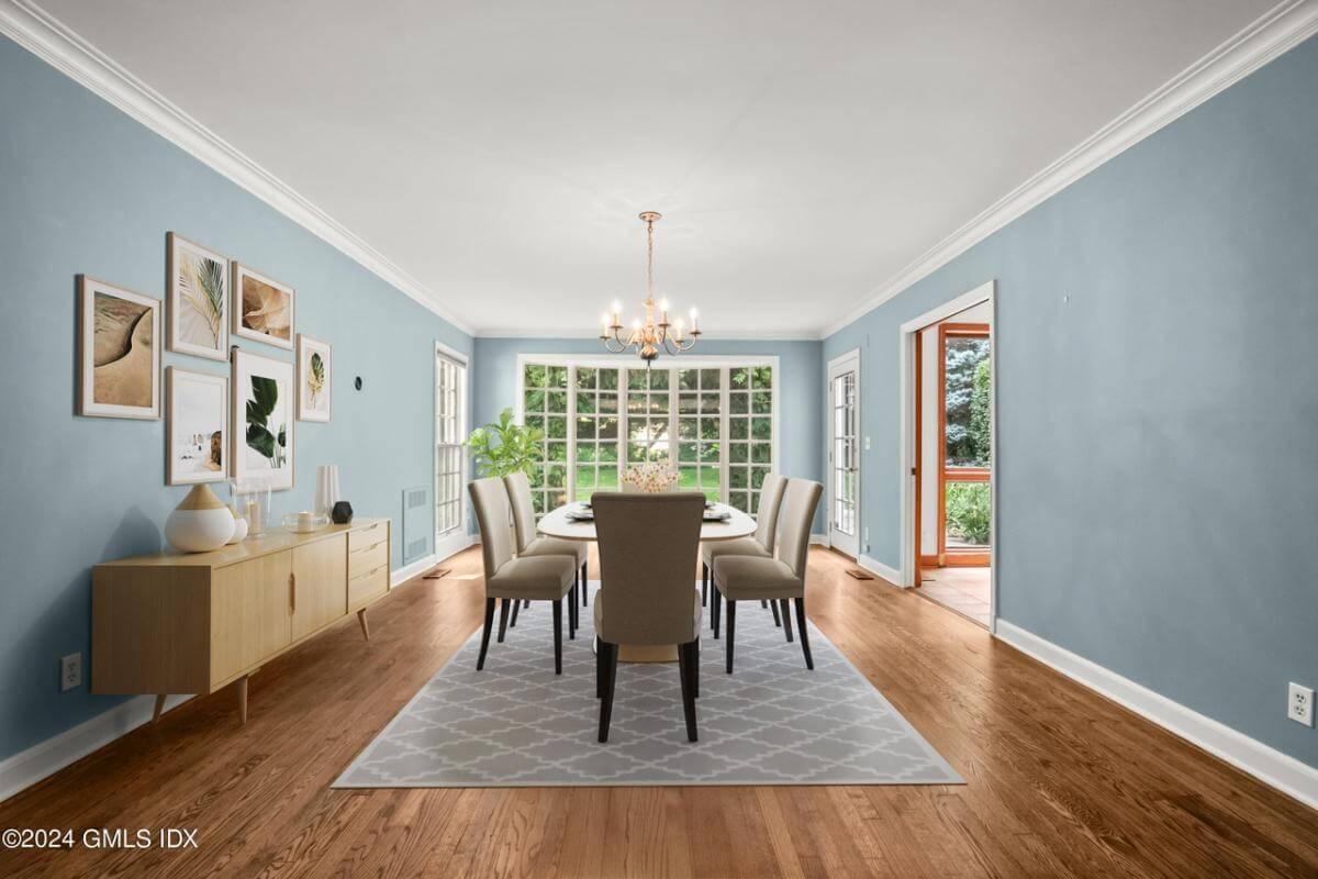 Elegant Dining Room with a Wall of Windows and a Serene Palette